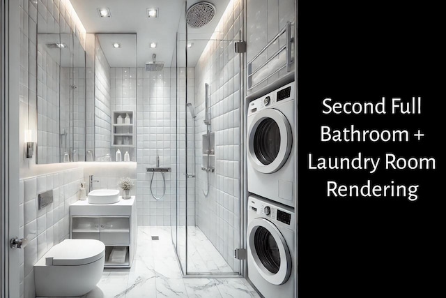 clothes washing area featuring laundry area, stacked washer / dryer, a sink, tile walls, and marble finish floor