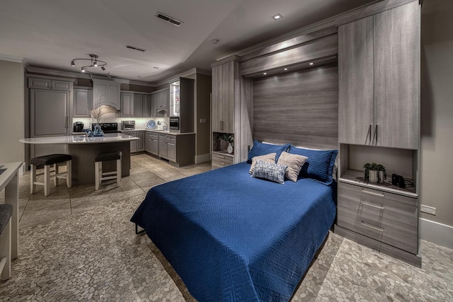 bedroom with ornamental molding, visible vents, and baseboards