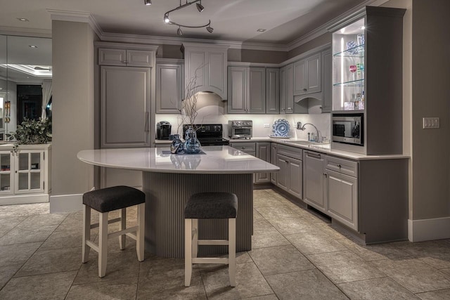 kitchen with black / electric stove, a toaster, premium range hood, gray cabinets, and stainless steel microwave