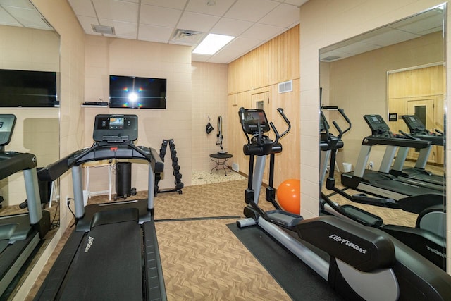 workout area with visible vents and a drop ceiling