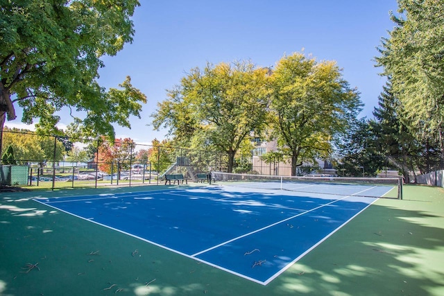 view of sport court featuring fence