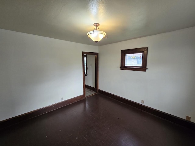 spare room with baseboards