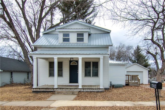 view of front of house with covered porch, metal roof, and an outdoor structure