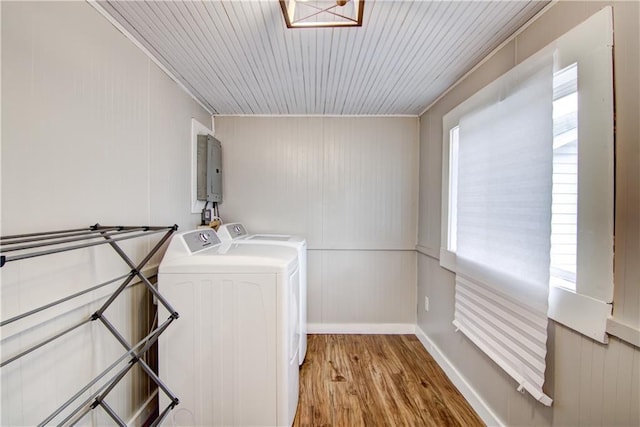 clothes washing area with laundry area, wooden ceiling, independent washer and dryer, and wood finished floors