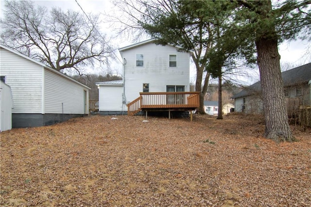 rear view of house featuring a deck and metal roof