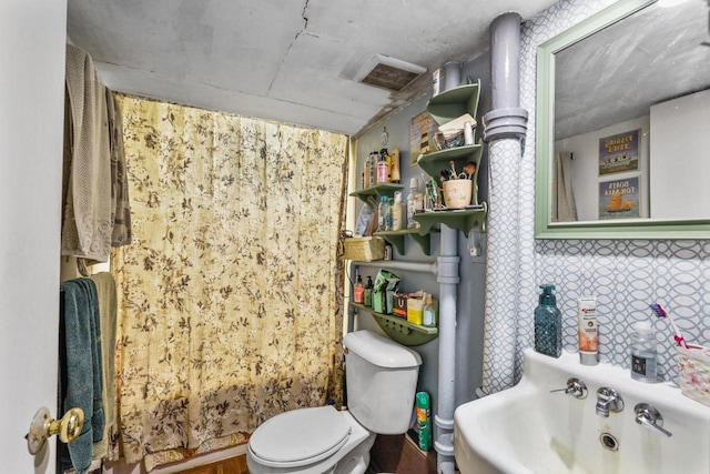 bathroom with visible vents, a sink, and toilet