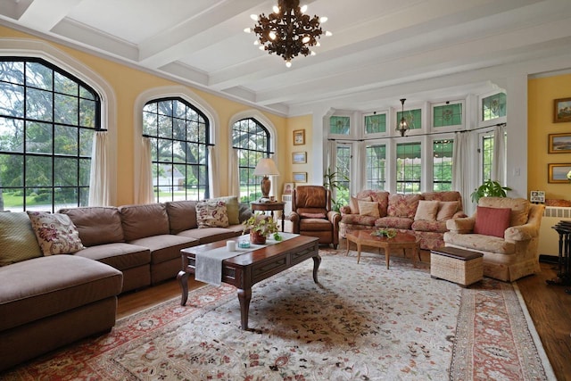 sunroom / solarium with beamed ceiling and an inviting chandelier