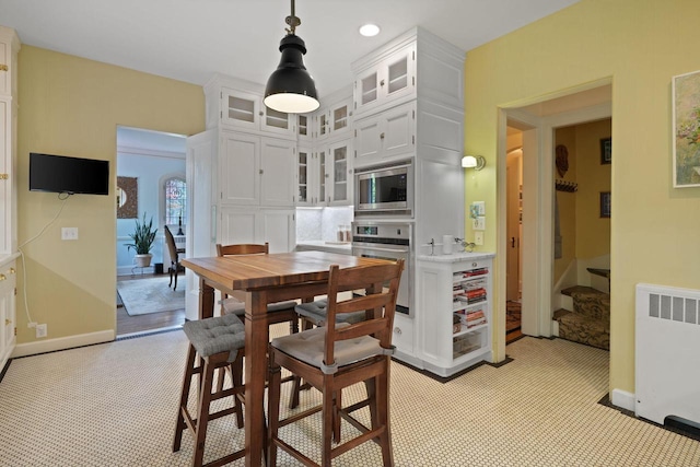 dining area featuring recessed lighting, light colored carpet, baseboards, stairway, and radiator heating unit