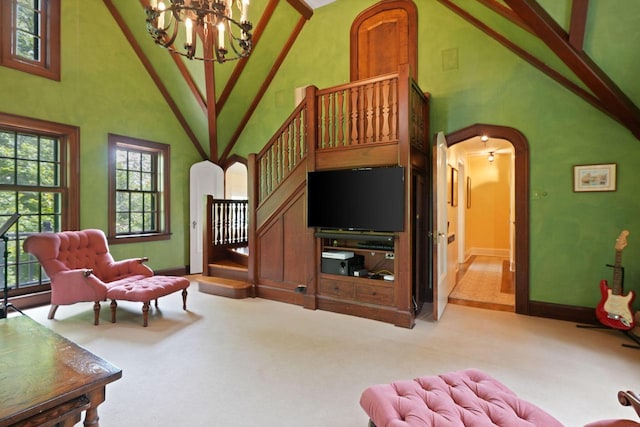 living room with carpet floors, arched walkways, a towering ceiling, and stairs