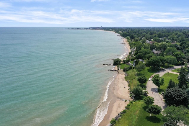 drone / aerial view featuring a water view and a view of the beach