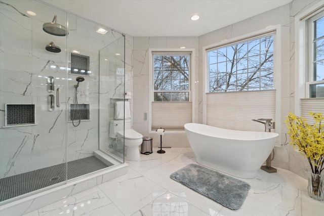 bathroom with toilet, recessed lighting, a freestanding bath, marble finish floor, and a marble finish shower