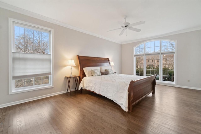 bedroom with dark wood-style flooring, multiple windows, and crown molding