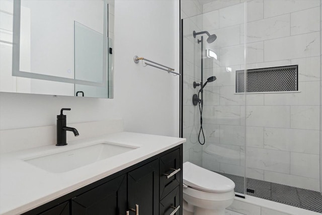 full bath featuring toilet, a stall shower, and vanity