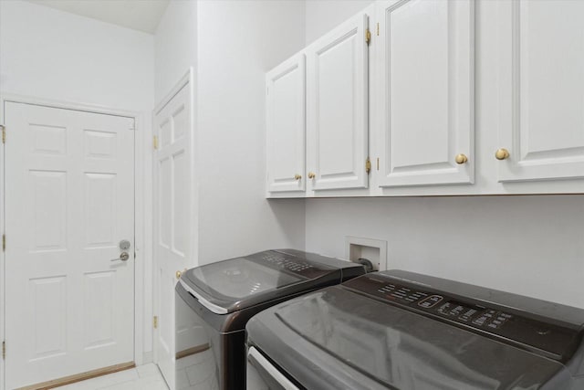 washroom with cabinet space and washing machine and clothes dryer