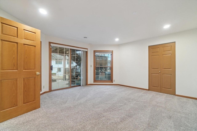 spare room featuring carpet floors, baseboards, and recessed lighting