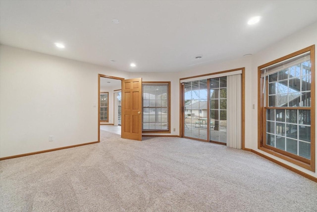 unfurnished room with recessed lighting, light carpet, and baseboards