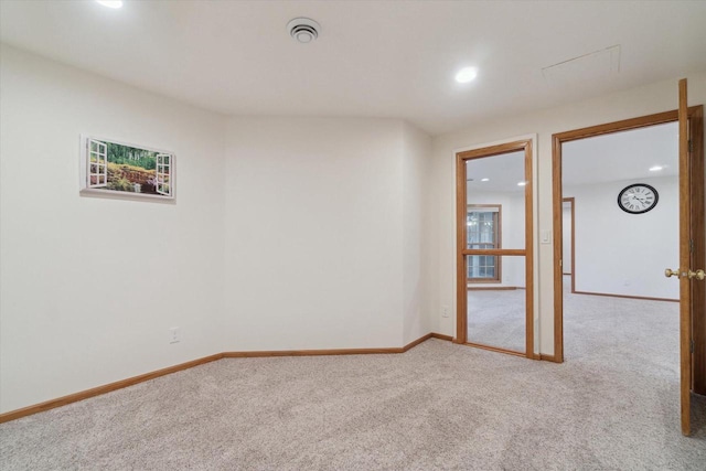 carpeted spare room with recessed lighting, visible vents, and baseboards