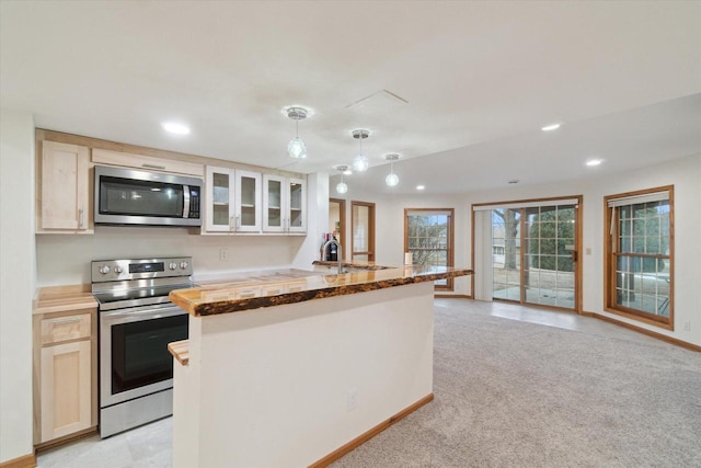 kitchen featuring recessed lighting, wooden counters, appliances with stainless steel finishes, glass insert cabinets, and light carpet