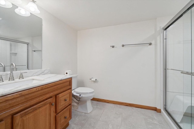 bathroom with toilet, a stall shower, baseboards, and vanity