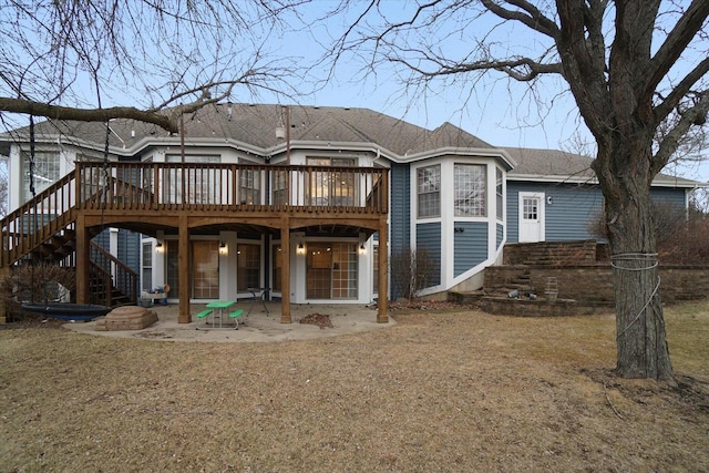 back of property featuring roof with shingles, a patio, a wooden deck, and stairs