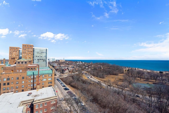 birds eye view of property featuring a view of city and a water view