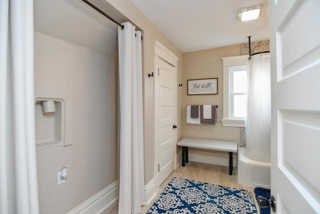 mudroom with baseboards and light tile patterned flooring