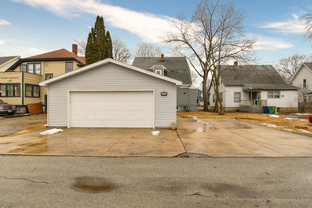 view of front facade featuring a garage and an outdoor structure