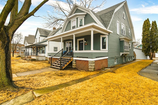 view of front of house featuring a porch, a shingled roof, and a gambrel roof