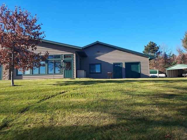 rear view of house with a yard