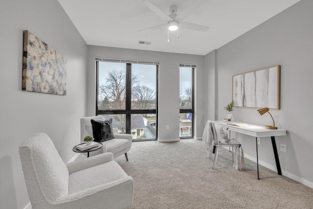 office space with a ceiling fan, baseboards, visible vents, and carpet flooring