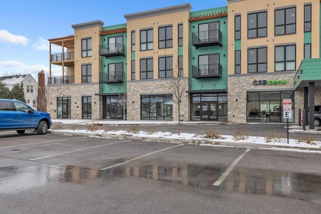 view of building exterior with uncovered parking