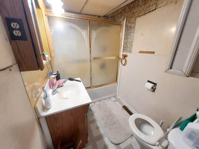 bathroom featuring shower / bath combination with glass door, vanity, toilet, and tile patterned floors