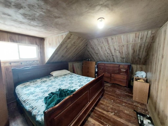 bedroom featuring lofted ceiling, dark wood-style floors, and wood walls