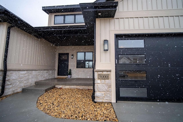 view of exterior entry with board and batten siding and stone siding