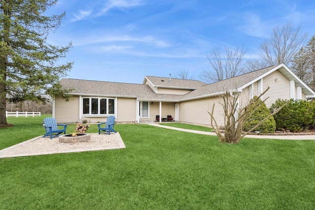 N2021 N Lake Shore Dr, Fontana, WI 53125 - rear view of property featuring a shingled roof, a lawn, a patio area, fence, and a fire pit