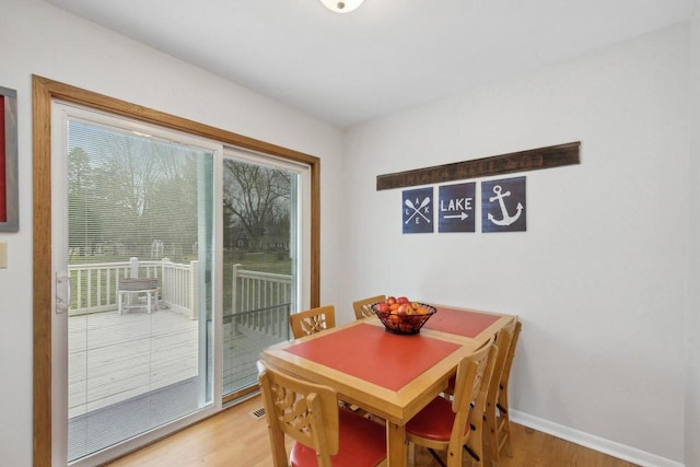 N2021 N Lake Shore Dr, Fontana, WI 53125 - dining area featuring light wood finished floors and baseboards