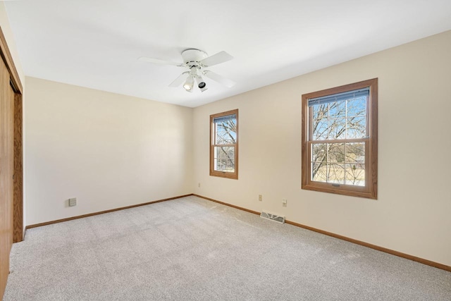 unfurnished bedroom with a ceiling fan, baseboards, visible vents, a closet, and carpet flooring