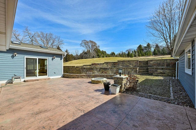 view of patio with a fire pit and fence