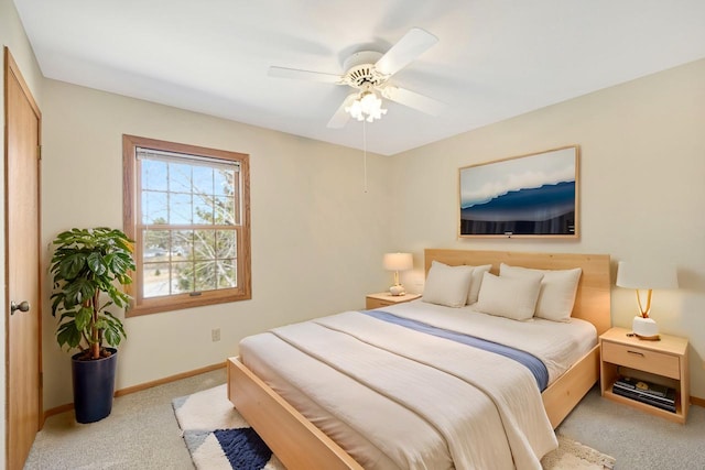 bedroom featuring baseboards, light carpet, and ceiling fan