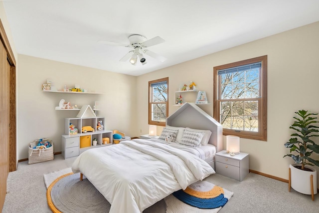 bedroom with multiple windows, baseboards, and carpet floors