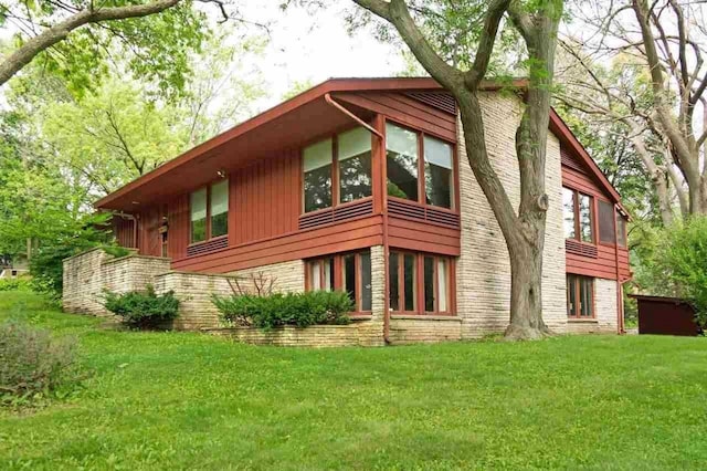 view of home's exterior with a lawn