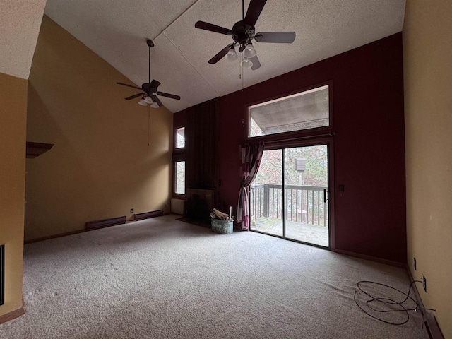 unfurnished living room with a textured ceiling, high vaulted ceiling, carpet, and baseboards