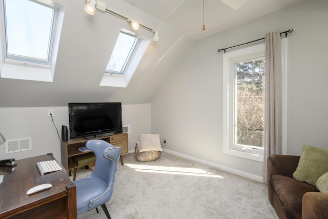 office area with lofted ceiling with skylight, baseboards, visible vents, and carpet floors