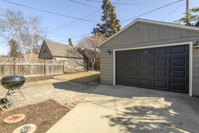 detached garage with driveway and fence