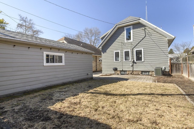 back of property with a patio, fence, a yard, central AC, and a shingled roof