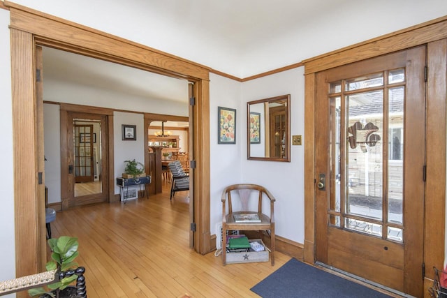 entrance foyer with light wood finished floors and baseboards