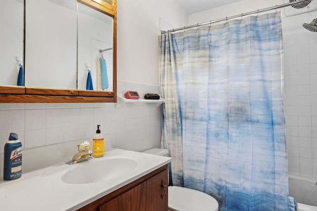 bathroom featuring toilet, shower / bath combination with curtain, tile walls, and vanity