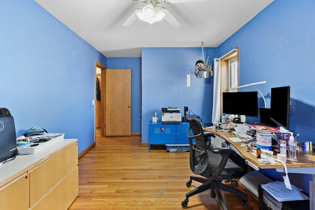 office area featuring light wood-style floors, baseboards, and a ceiling fan