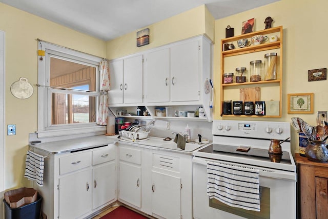 kitchen with light countertops, white cabinetry, open shelves, and white electric range oven