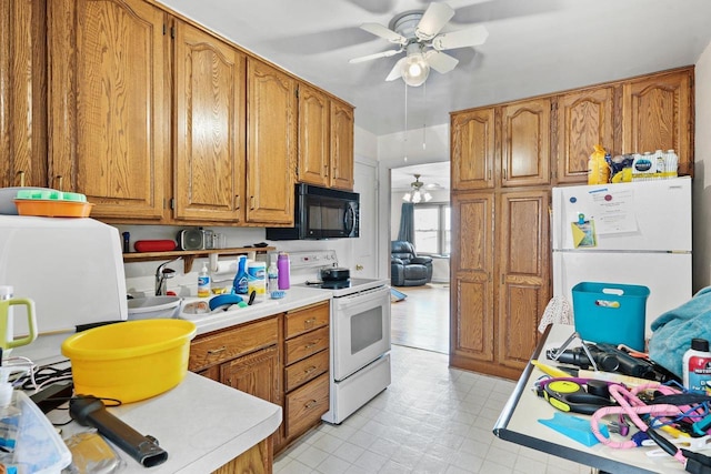 kitchen featuring light countertops, white appliances, brown cabinetry, and a ceiling fan